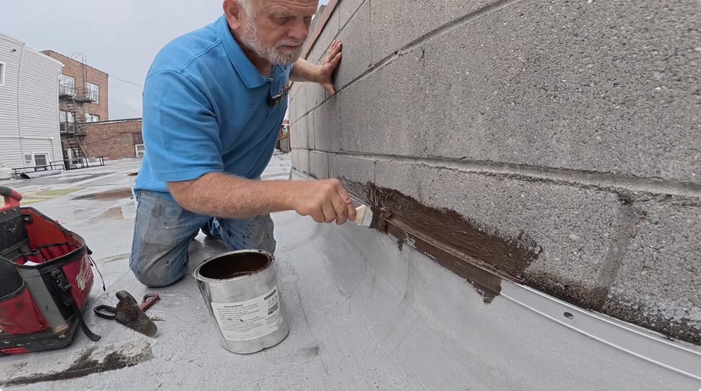 Making a Transition repair between a parapet wall and a termination bar