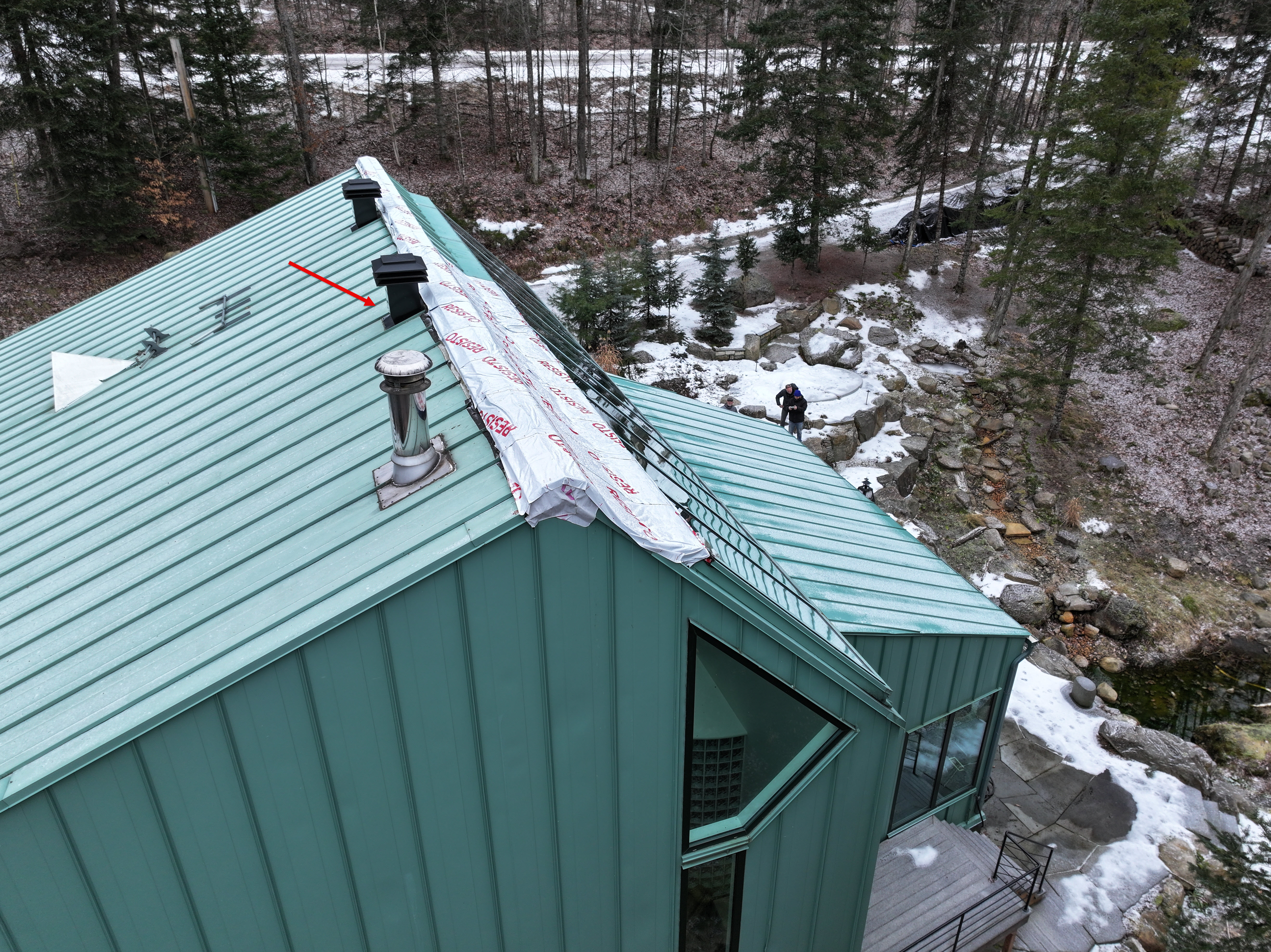 Source photo from the leak investigation. The existing arrow points to a vent considered earlier in the discussion; the leak source was not confirmed.