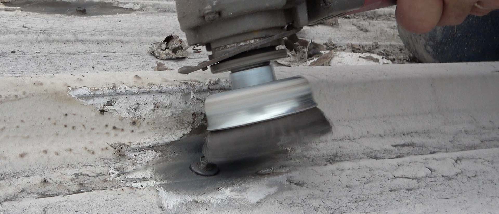 Use an angle grinder with stiff metal bristles to clean around metal screws