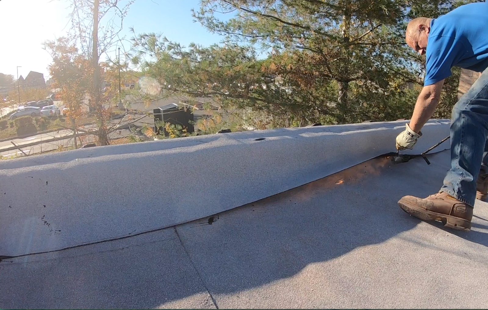 Roofing membrane over half-round clay parapet caps — During membrane installation